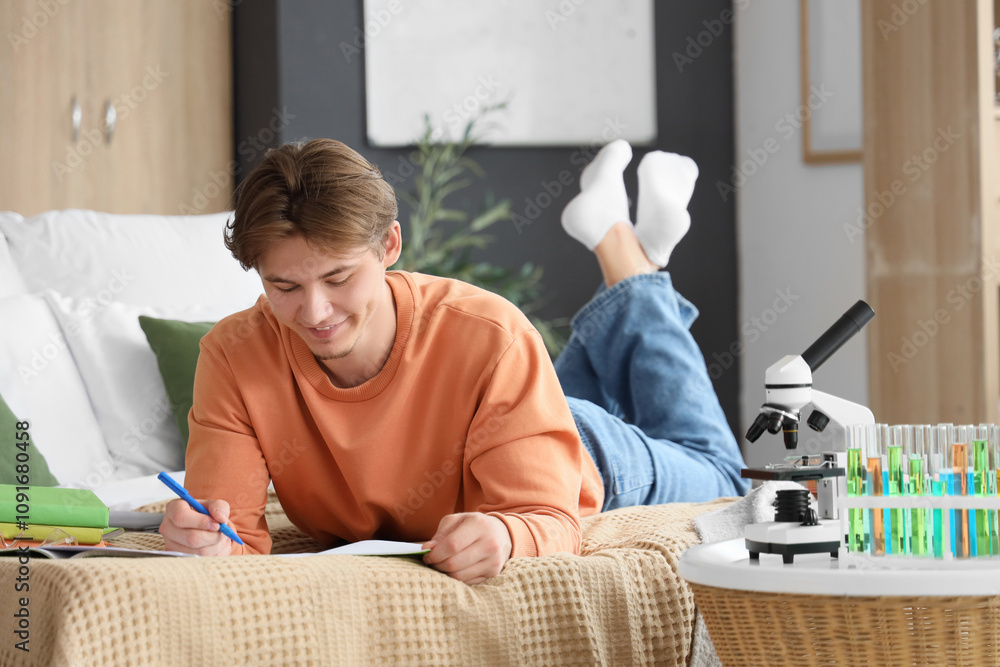 Male student studying Chemistry in bedroom