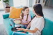 © deagreez - Photo of lovely charming mommy and daughter sit sofa weekend time together watch movie indoors cozy living room