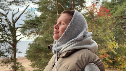 Wall Mural - handsome bearded young man relaxes in nature in autumn and enjoys fresh air, breathing deeply