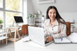 © Pixel-Shot - Beautiful businesswoman working with laptop and folder at desk in office