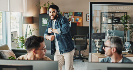 Business, headphones and man dance to music or programmer celebrate software project success. Employee, radio or listening to audio, winner or excited engineer singing song at creative startup office