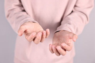 Wall Mural - Man holding something on grey background, closeup