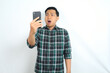 © M Alfan Setyawan - shocked asian man looking at smartphone show confused expression isolated on white background