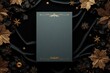 © indofootage - A flat lay of a blank standing menu card surrounded by golden ornaments on a dark velvet background,
