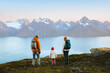 © EVERST - Family vacations hiking tour in Norway, parents traveling with child hiking together active outdoor vacations. Mother, father, and kid backpacking in mountains enjoying Lyngen Alps landscape