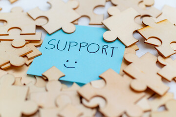 Poster - Boosting business support with puzzle pieces office setting visual content bright environment close-up collaboration concept