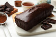© New Africa - Tasty sponge cake, pieces of chocolate and cocoa powder on white table, closeup