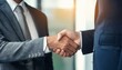 © SSuperTier - A close-up of businessmen shaking hands with a partner, symbolizing greetings, negotiations, partnerships, mergers, and acquisitions. The scene reflects concepts of business collaboration.