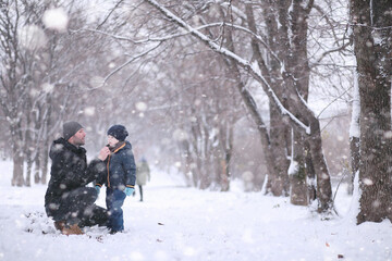 Wall Mural - Kids walk in the park first snow