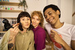 © alvaro - Multiethnic friends applying makeup together at home