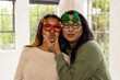 © Wavebreak Media - Christmas time, grandma and asian female teenager wearing festive glasses, at home