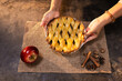 © Wavebreak Media - Senior woman holding freshly baked apple pie with spices and apple on table, at home