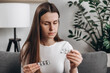 © Yura Yarema - Close up of young woman holding pill medicine pack reading label text about medical information, looking at medicine instructions side effects, pharmacy medicament concept. Health care treatment