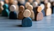 © TeteraX - Wooden figures of various colors are arranged on a table, symbolizing unity and diversity