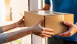 © anandart - Delivery concept: person accepting delivery boxes from a professional delivery person at his home