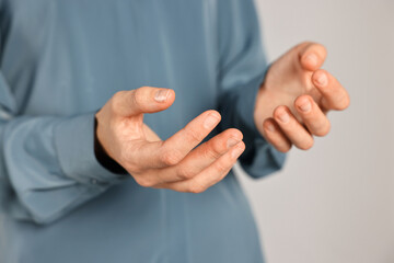 Wall Mural - Man holding something on grey background, closeup