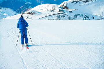 Wall Mural - Young man athlete skiing in snow mountain - Skier riding down for winter sport competition - Travel and vacation concept - Focus on his body