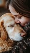 © Hryhor Denys - A girl embraces her golden retriever, sharing a tender moment on National Puppy Day, surrounded by warmth and affection in a cozy setting