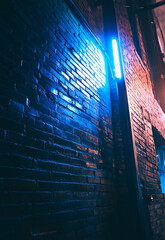 Wall Mural - Blue neon light illuminating a shape on a brick wall at night Vibrant urban scene featuring a brick wall illuminated by blue neon light at night A blue neon light forms a striking shape 

