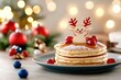 © dashtik - Festive reindeer pancakes with berries and candles on a holiday table