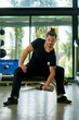 © bank215 - A hansome man in black shirt workout with weight trainning in sport gym.