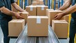 © porpia - Two workers moving sealed cardboard boxes on a conveyor belt in a warehouse, representing logistics, packaging, and shipping operations.