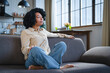 © InsideCreativeHouse - Young calm black woman relaxing sit on comfortable sofa in modern living room, lazy happy african lady resting on couch breathing fresh air enjoy peace of mind no stress free on couch at home