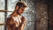 © GoodandEvil - Muscular man under shower with water droplets cascading