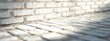 © Alpa - Close-up detail of white brick wall texture with sunlight shadow