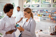 © Davor - Female pharmacist helping woman customer at pharmacy drugstore