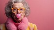 © Trushchenko_O - An older woman in a pink coat and yellow glasses blowing bubbles. Concept of whimsy and playfulness, as the woman is engaging in a fun activity that is typically associated with children