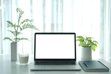 Wall Mural - Laptop and notebook and milk on white table, interior workspace