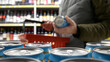 © Stockah - A male buyer places a beer can into a shopping cart