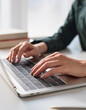 © anandart - Typing on laptop closeup, chatting in Facebook, meeting website. Blogger, journalist writing new article.