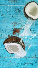 Poster - Super Slow Motion Shot of Falling Coconut on Wooden Background, top shot, 1000 fps.