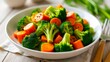 © dana - Vegetable salad in a white plate on a wooden table, close-up. Broccoli and carrot, healthy side dish. Healthy food, and balanced nutrition