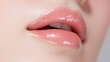 © Lifestyle Images - A woman's lips are painted with a shiny, pink lip gloss