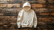 © creatfive - White hoodie on a wooden background, flat lay.