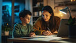 © goami - mother and child making school homework, reading books and writing in notebook, happy family atmosphere in cozy domestic room