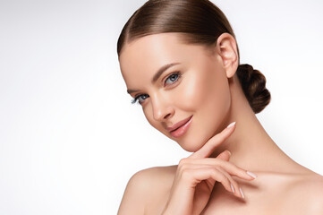 beautiful young woman with clean fresh skin touching her face . girl facial treatment . cosmetology 