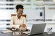 © Liubomir - Businesswoman feels arm pain while working at a laptop in modern office. Woman in glasses, formal attire supports elbow joint, indicating discomfort. Contemporary workspace fosters productivity