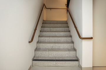 Wall Mural - view of stairs with golden railing in modern building