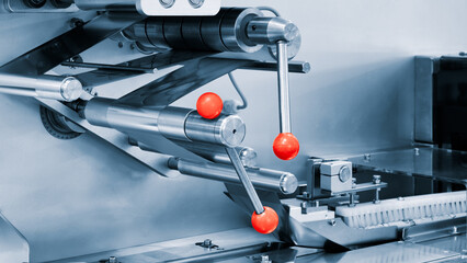 Poster - A machine with three red buttons. The machine is silver
