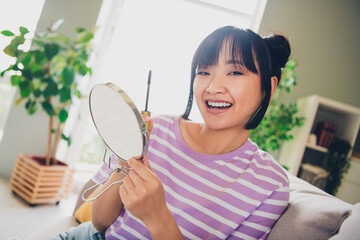 Wall Mural - Photo of adorable sweet lady wear violet striped t-shirt applying mascara indoors room home house