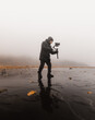 © Centric  - Videographer using a gimbal to record smooth footage in a misty and wet environment, creating a moody and atmospheric scene