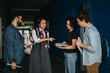 © qunica.com - A group of students and a professor engage in discussion between classes, fostering a collaborative learning environment and exchanging ideas in an academic setting.