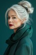 © Erich - Elegant senior woman with silver hair posing in stylish teal dress