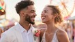© Pro Hi-Res - Couple enjoying a joyful moment at a carnival during sunset with vibrant lights and rides in the background.