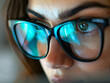 © Akilmazumder - Close up view of focused business person wears computer glasses, looking at pc screen with computer reflection using internet, reading, watching, working online late.