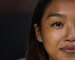 © Wavebreak Media - Close-up of asian female teenager smiling with nose ring and earrings, copy space, at home